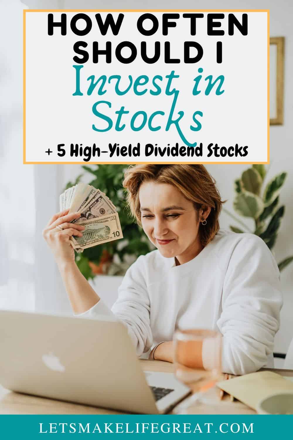 woman sitting at desk looking at laptop and fanning a stack of dollar bills with text overlay - How Often Should I Invest in Stocks (5 high-yield dividends)