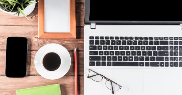 How to build an email list - laptop, phone, coffee, and stationary at a desk